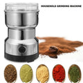 Household grinding machine with ground spices and raw ingredients on a white background